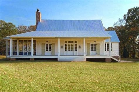 acadian style house with metal roof|first acadian style house.